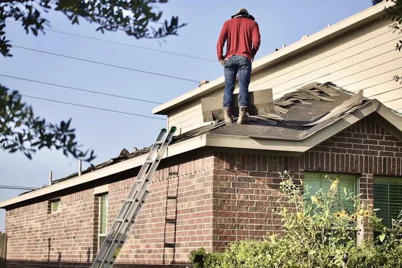 Professional roofer working on a residential roof in Oakwood Acres